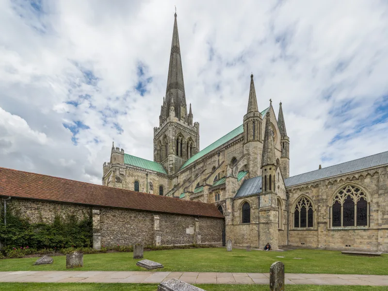 Chichester Cathedral exterior with its spire against a blue sky